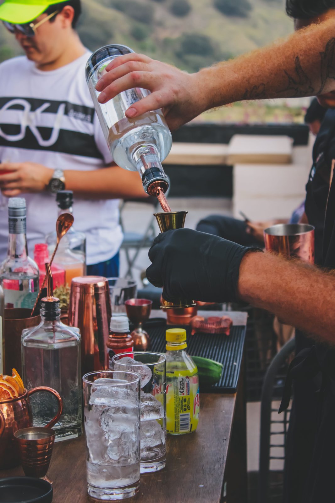 Precise jigger pour behind the bar (stock photo)