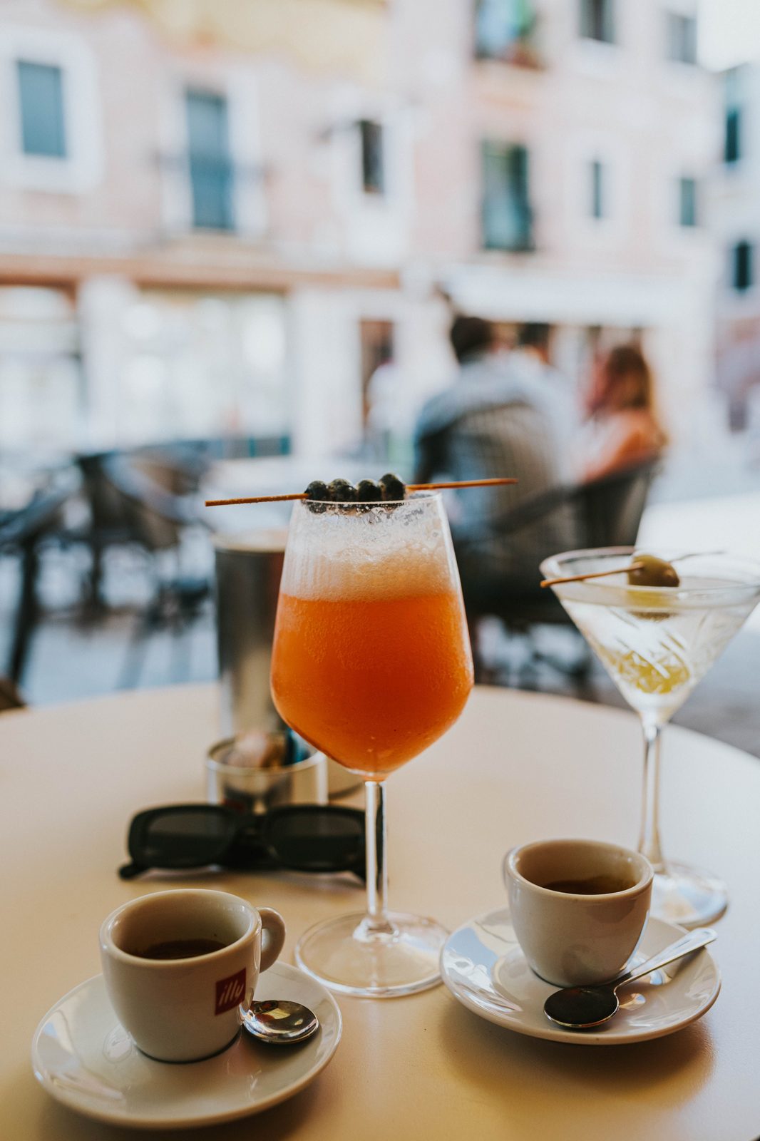 Brunch cocktail and espresso at a café table (stock photo)